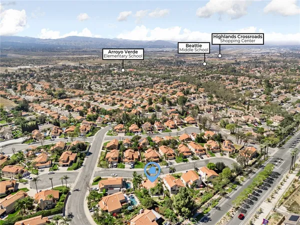 an aerial view of residential houses with city view