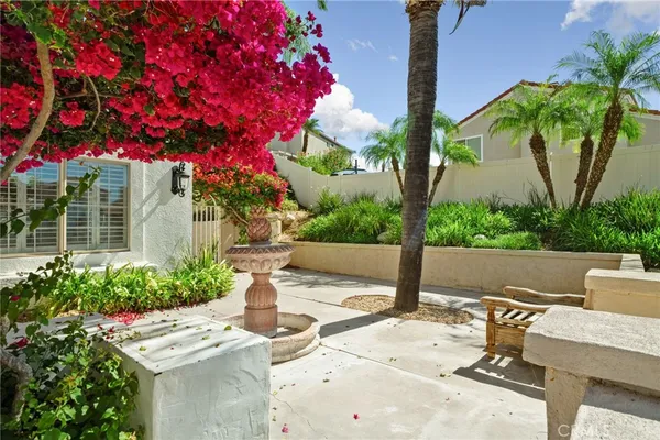 a view of a patio with table and chairs and potted plants