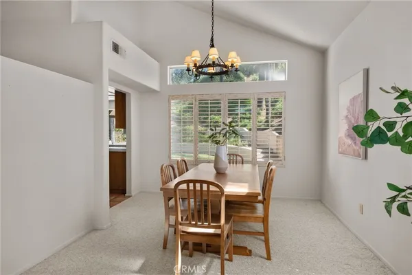 a dining room with furniture and window