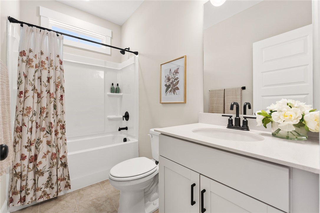 334 Summerall Drive Anderson, SC 29621 - Photo 10 of 28 This bright bathroom features a vanity with a sleek sink and a shower-tub combination.