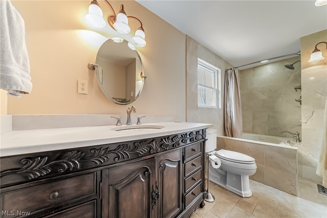 16775 Snyder Road Chagrin Falls, OH 44023 - Photo 14 of 31 Full bathroom with vanity, toilet, tile floors, and shower / bath combo with shower curtain