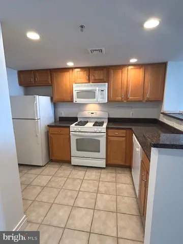 a kitchen with a stove top oven and cabinets