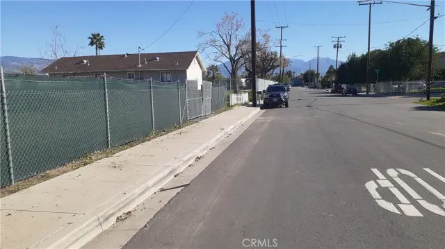 a view of a park with a car parked on the road