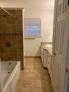 2812 56th Street Lubbock, TX 79413 - Photo 8 of 14 a bathroom with a tub a sink a mirror and a shower