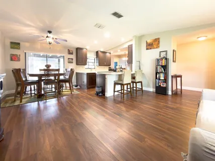 a view of a dining room with furniture wooden floor and chandelier