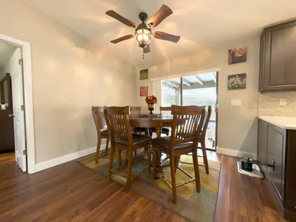 a view of a dining room with furniture and a chandelier