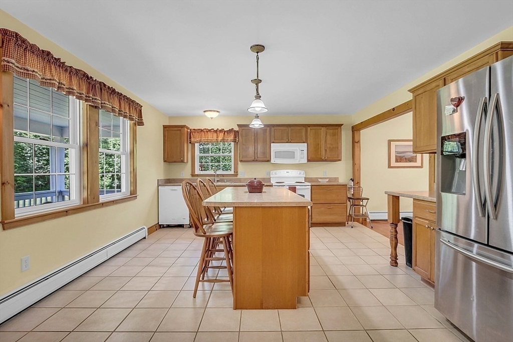 371 Walnut Hill Road Orange, MA 01364 - Photo 11 of 41 a living room with a large window a table and chairs
