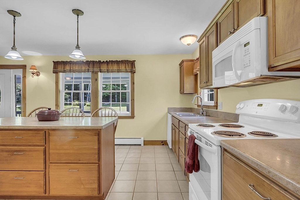 371 Walnut Hill Road Orange, MA 01364 - Photo 12 of 41 a kitchen with a stove a sink a refrigerator and chairs