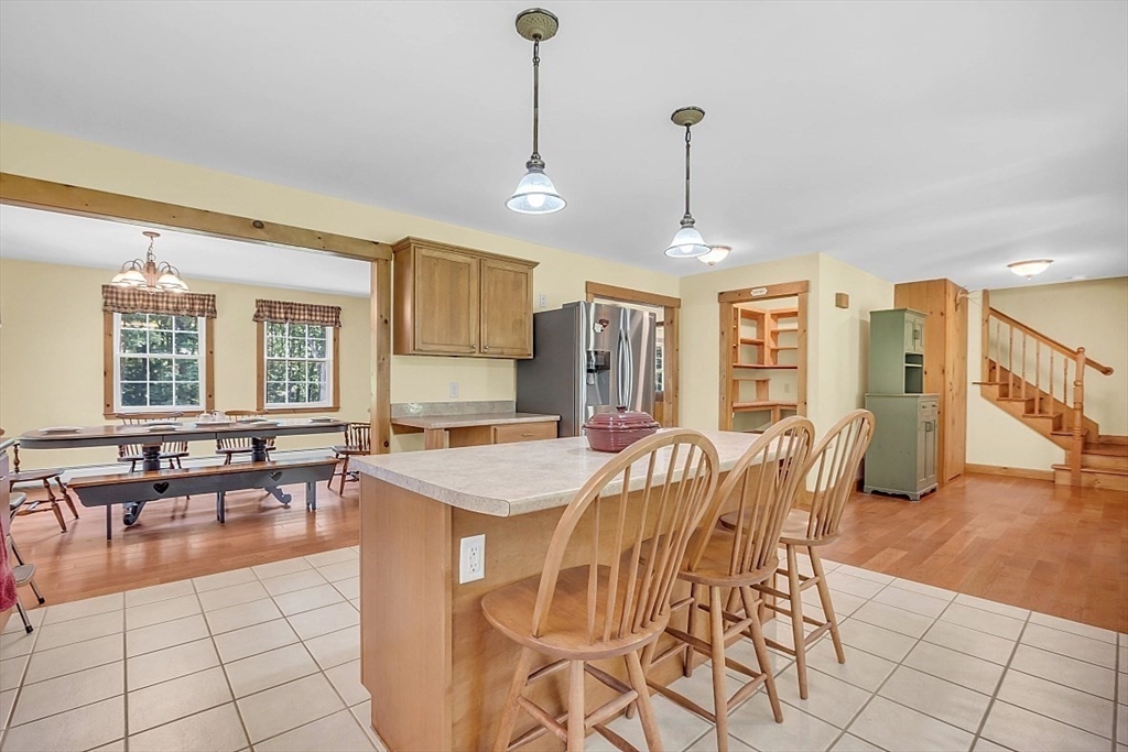 371 Walnut Hill Road Orange, MA 01364 - Photo 13 of 41 a view of a dining room and livingroom with furniture wooden floor a chandelier