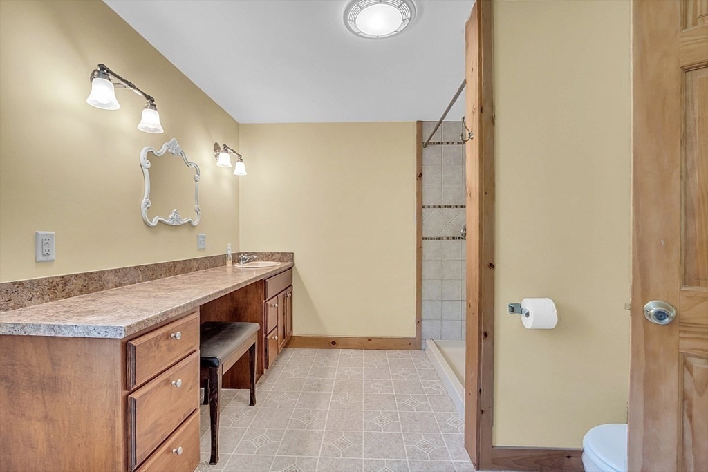 371 Walnut Hill Road Orange, MA 01364 - Photo 26 of 41 a bathroom with a sink and mirror