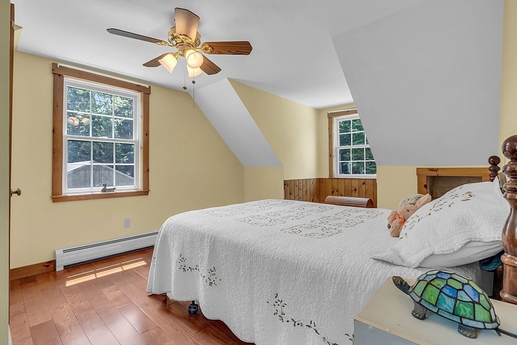 371 Walnut Hill Road Orange, MA 01364 - Photo 28 of 41 a bedroom with a bed and a chandelier