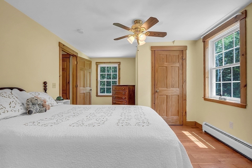 371 Walnut Hill Road Orange, MA 01364 - Photo 29 of 41 a bedroom with a bed and wooden floor