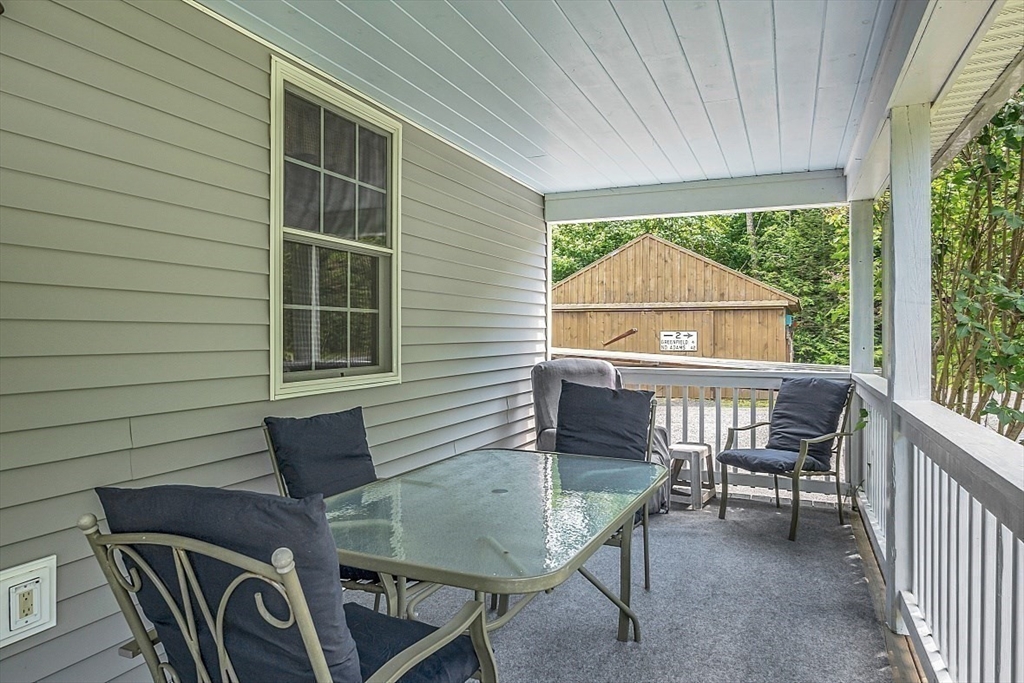 371 Walnut Hill Road Orange, MA 01364 - Photo 4 of 41 a view of a patio with a table and chairs
