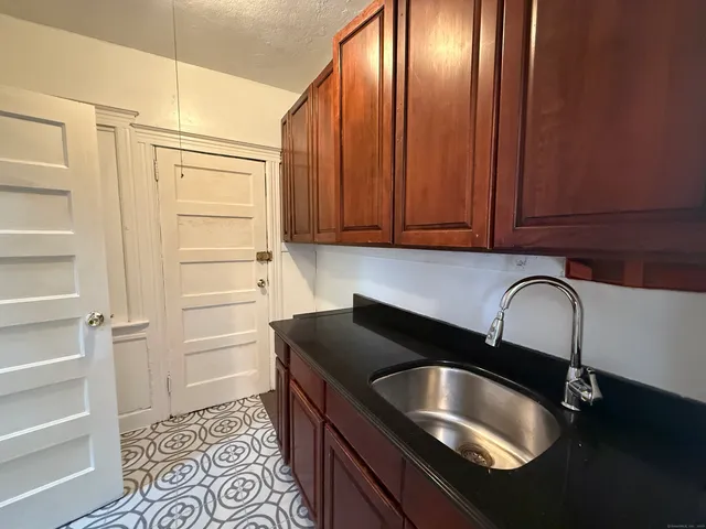 a kitchen with a sink and cabinets