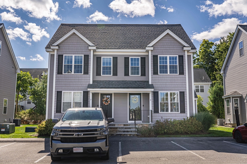 5 Riley Road, Unit 5 Tyngsboro, MA 01879 - Photo 1 of 4 a car parked in front of a house