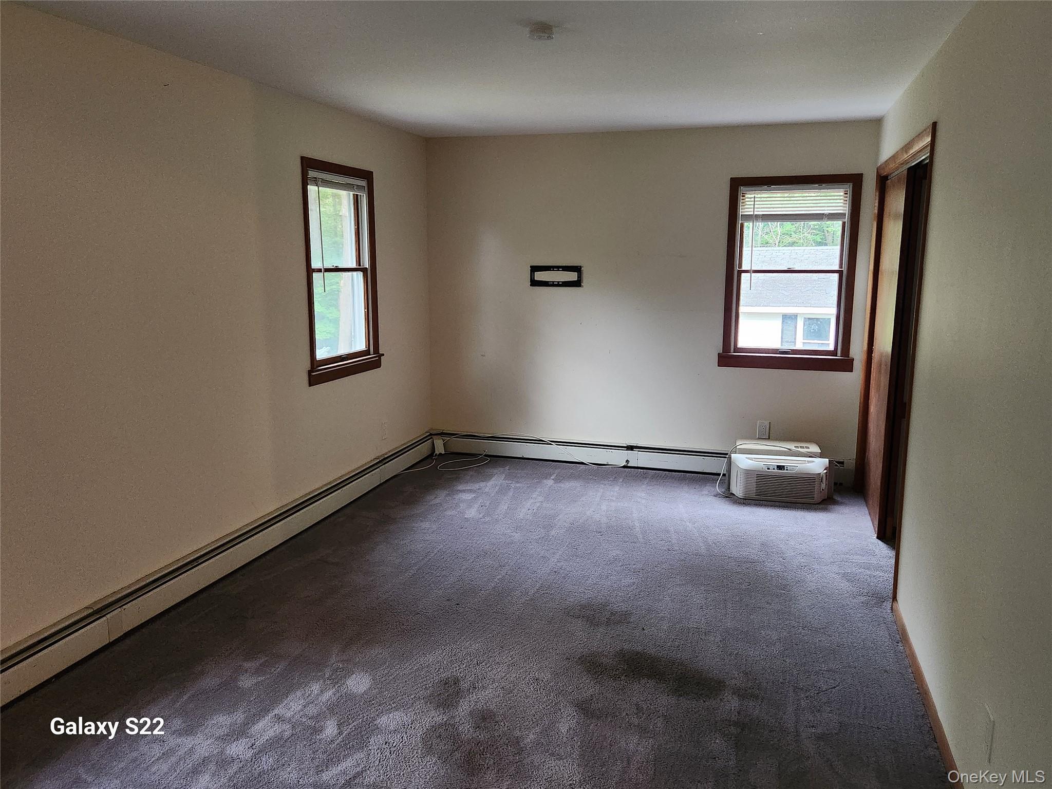 116 Croton Park Road Cortlandt Manor, NY 10567 - Photo 12 of 16 an empty room with windows