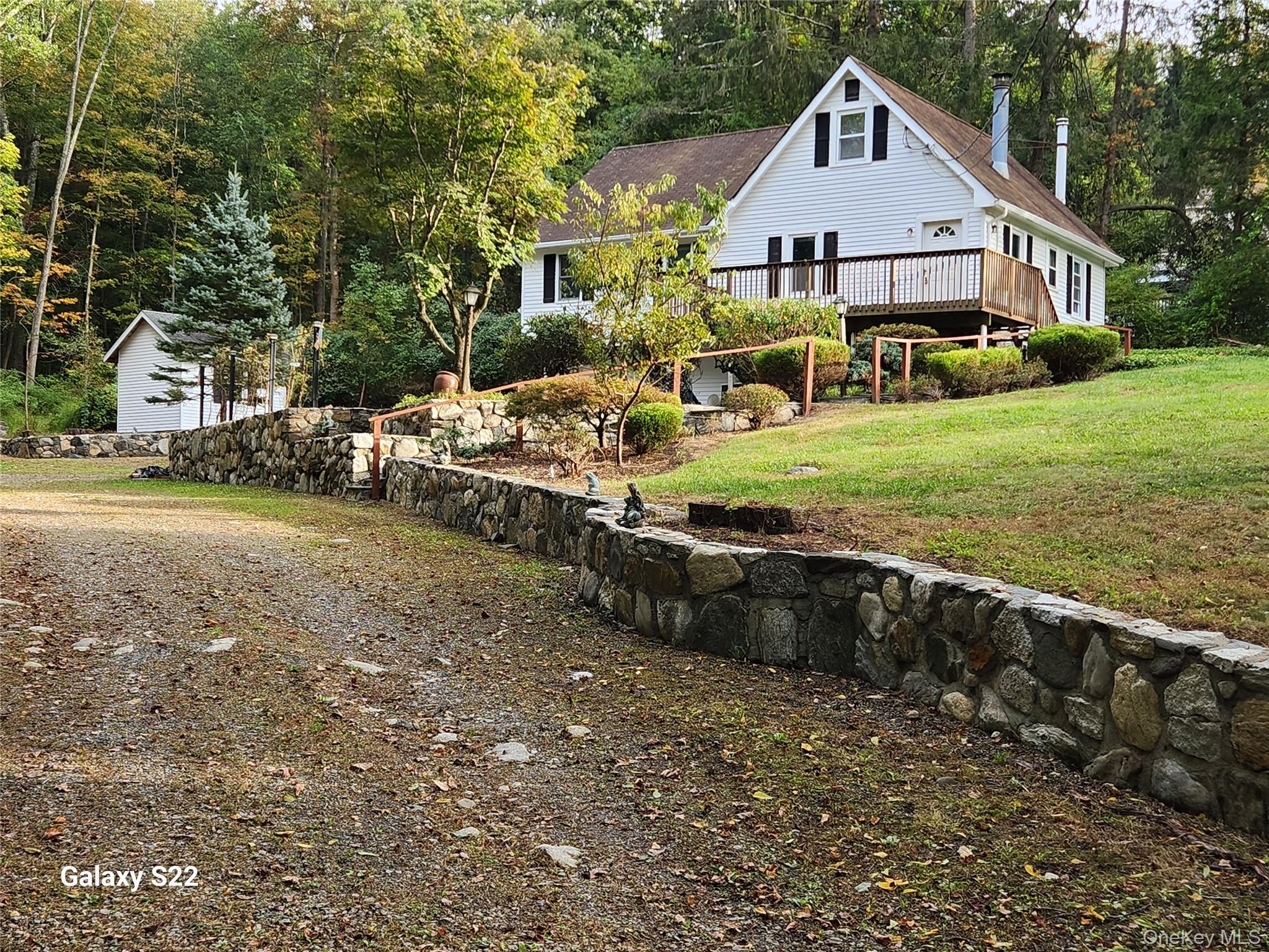 116 Croton Park Road Cortlandt Manor, NY 10567 - Photo 5 of 16 a view of a house with a yard