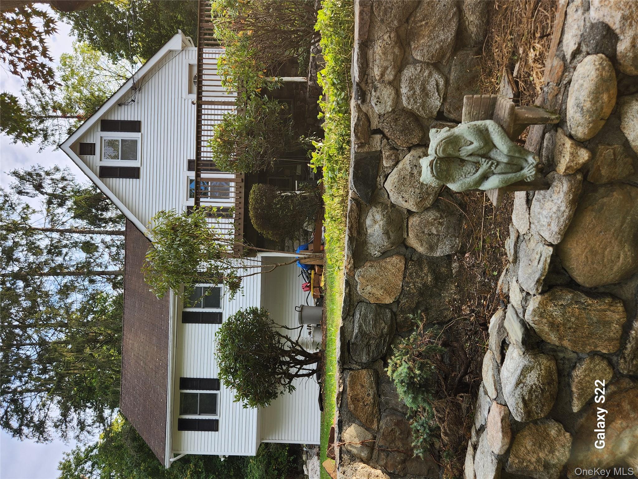 116 Croton Park Road Cortlandt Manor, NY 10567 - Photo 6 of 16 a front view of a house with a yard and potted plants