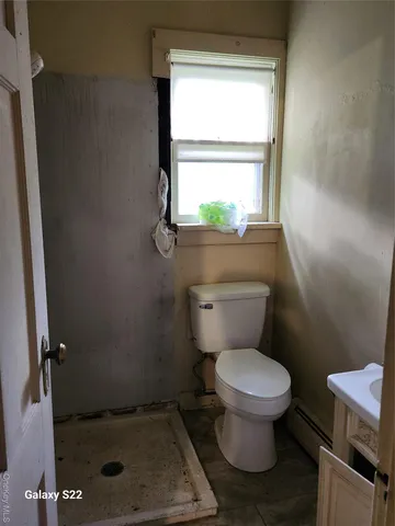 a bathroom with a toilet and a shower