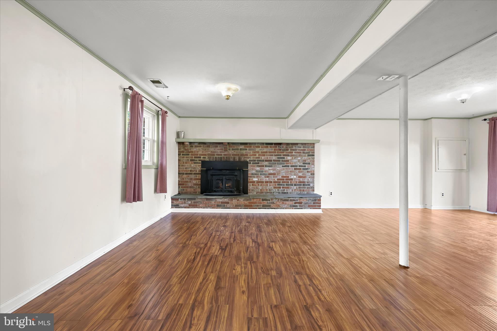 14821 Ridge Oak Drive Boyds, MD 20841 - Photo 34 of 49 an empty room with wooden floor and fireplace