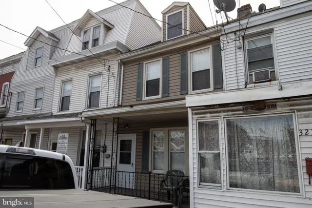 a front view of a residential apartment building with a glass door