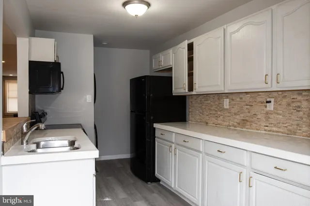 a kitchen with a refrigerator stove and microwave