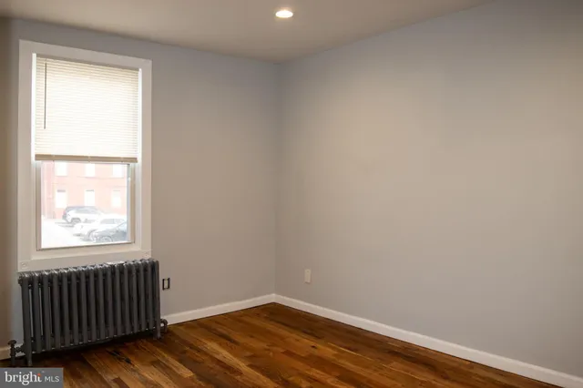a view of walk in closet with wooden floor