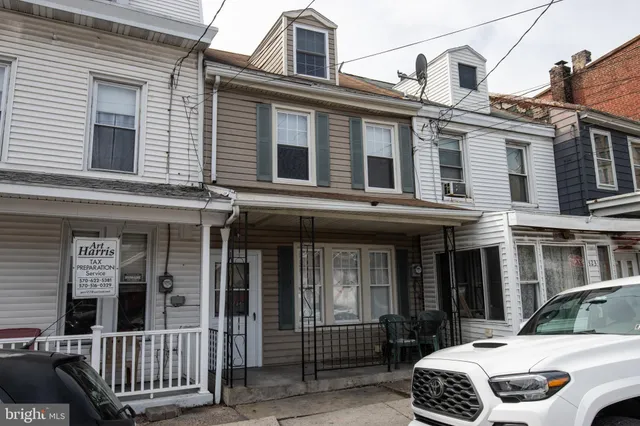 a view of a house with a small deck