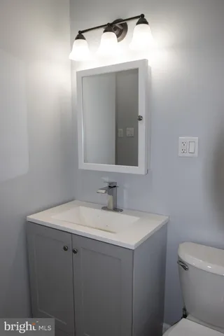 an empty room with wooden floor and a window