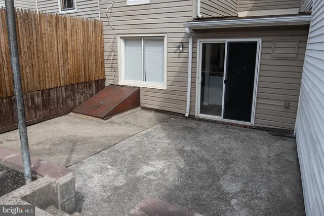 a view of a house with a yard and wooden fence