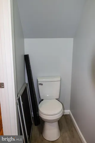 a white toilet sitting next to a sink