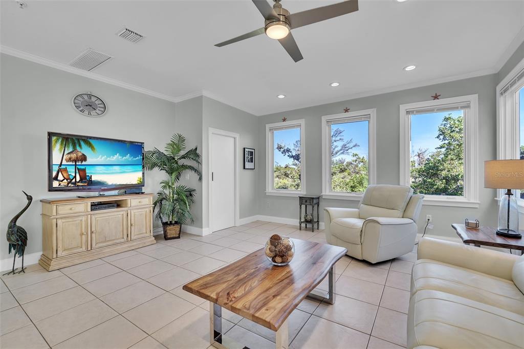 848 Evergreen Way Longboat Key, FL 34228 - Photo 7 of 66 a living room with furniture and a flat screen tv