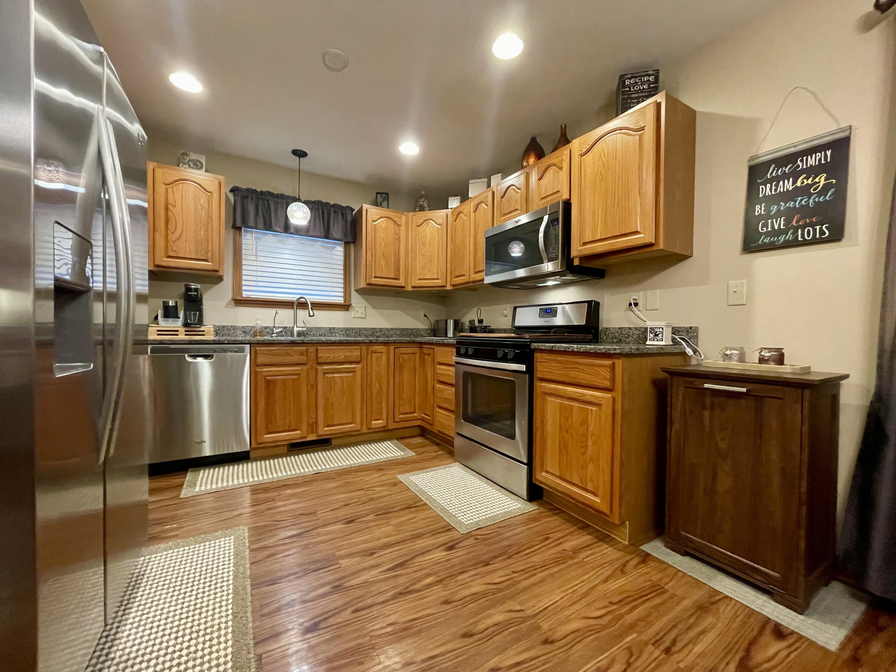 1001 Institute Street Valparaiso, IN 46383 - Photo 4 of 20 a kitchen with stainless steel appliances granite countertop wooden cabinets a stove top oven a sink and dishwasher