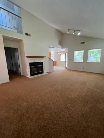 a view of a livingroom with an empty space and a fireplace