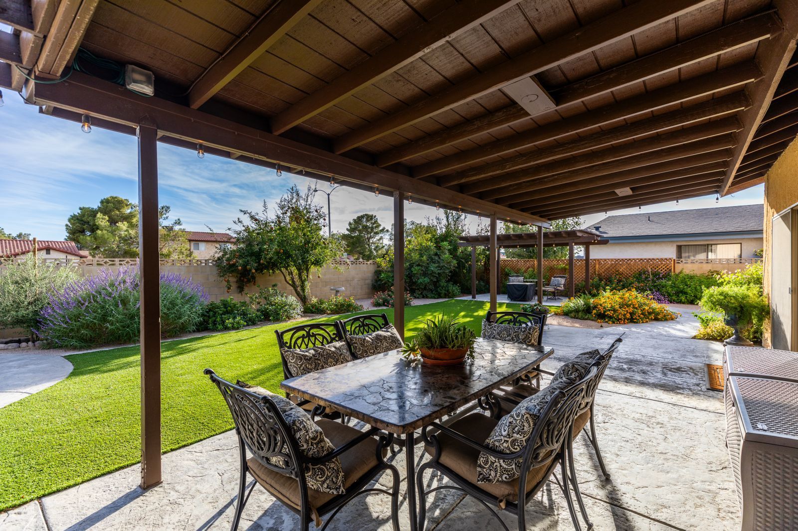 815 Hurschell Avenue Ridgecrest, CA 93555 - Photo 35 of 43 a view of an outdoor dining space with a table and chairs under an umbrella