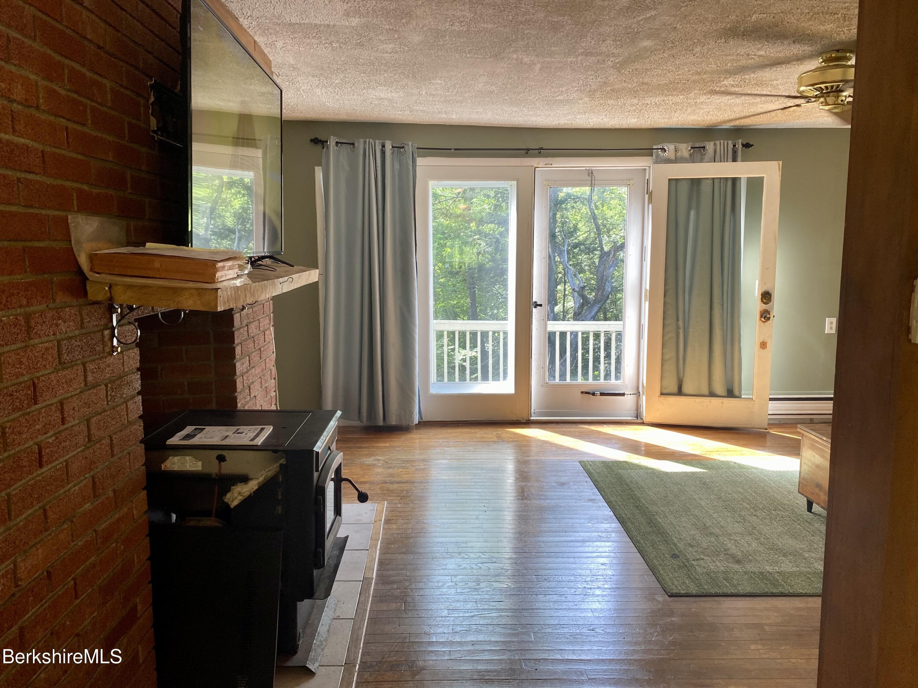 75 Roys Road New Ashford, MA 01237 - Photo 12 of 49 living room with pellet stove