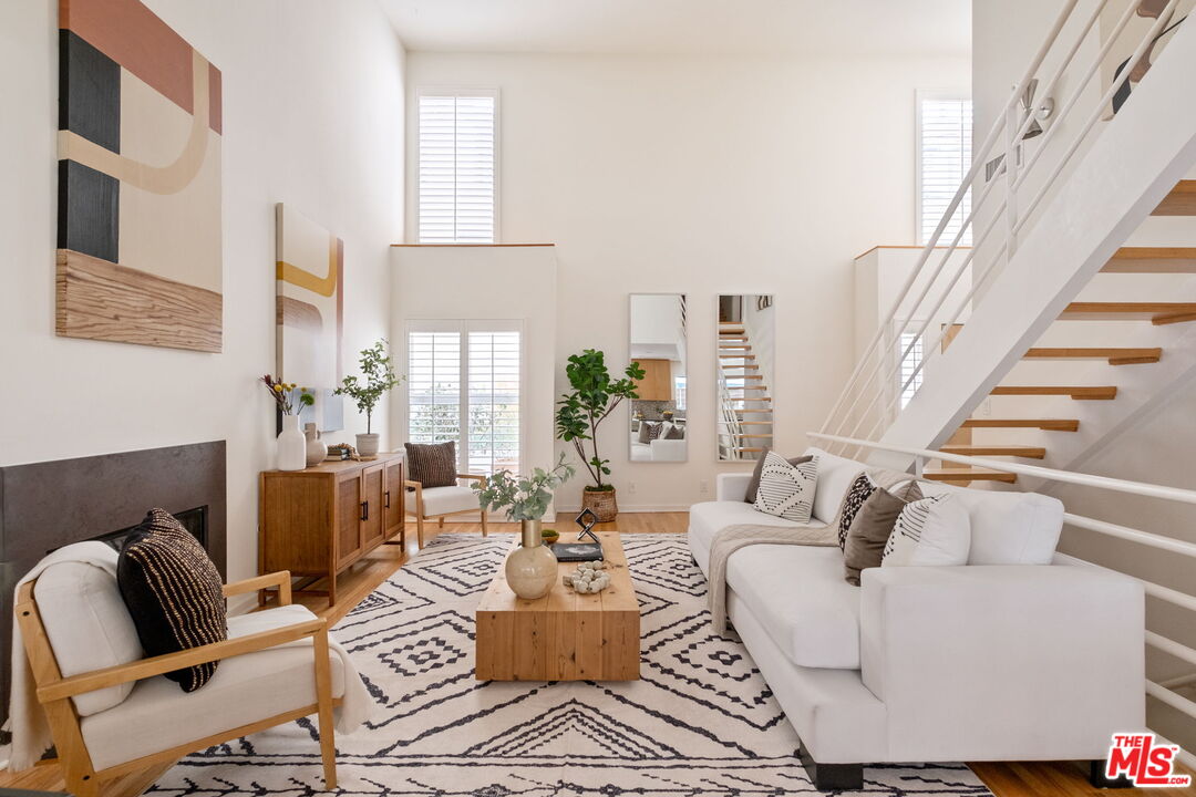a living room with furniture or couch and a potted plant