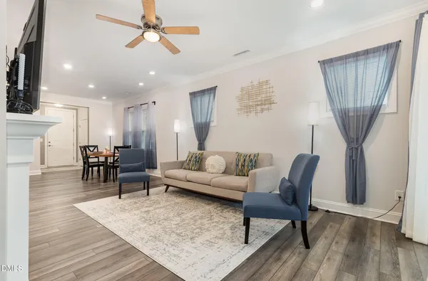 a living room with furniture a flat screen tv and a fireplace