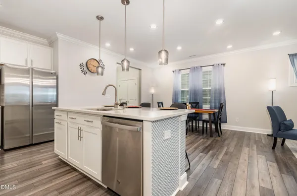 a kitchen with stainless steel appliances a sink a stove a microwave and cabinets