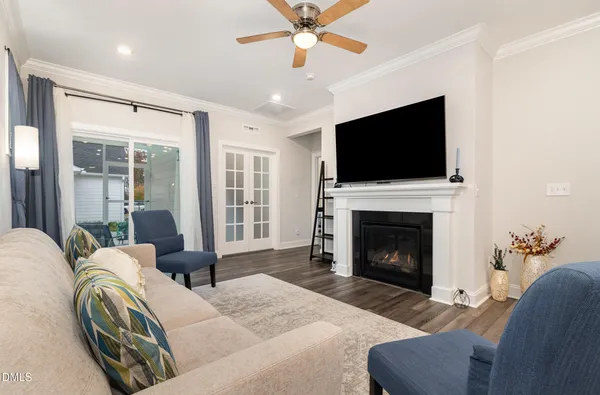 a living room with furniture and a wooden floor