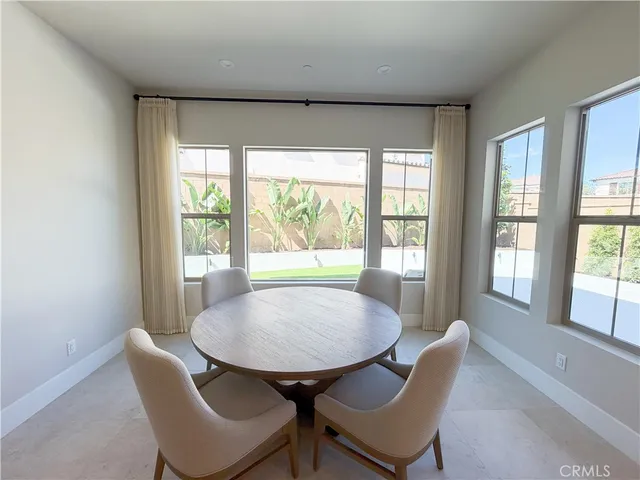 a view of a dining room with furniture window and outside view