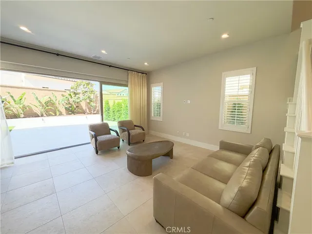 a living room with furniture and large windows