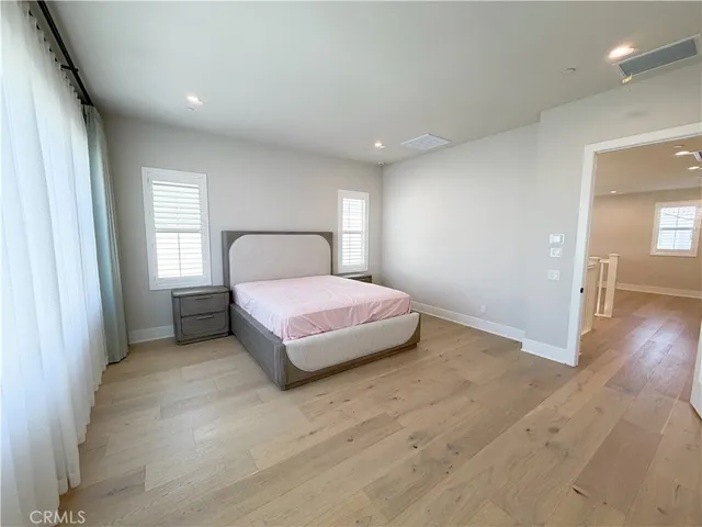 a spacious bedroom with a bed and a window