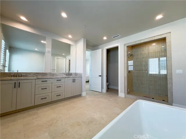 a bathroom with a granite countertop sink mirror and shower