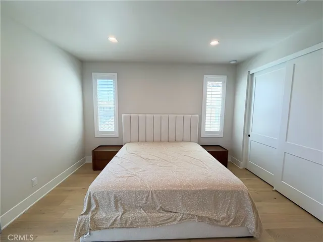a spacious bedroom with a bed and a window