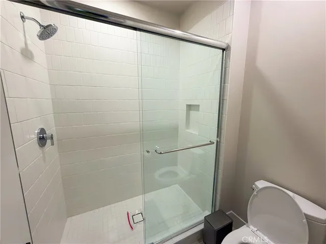 a bathroom with a shower and toilet
