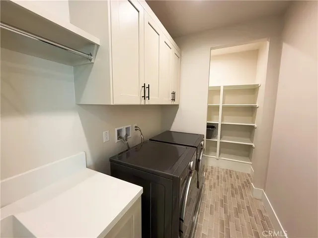 a kitchen with a cabinets and a stove top oven