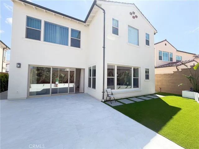a view of a white house with a yard and a large window