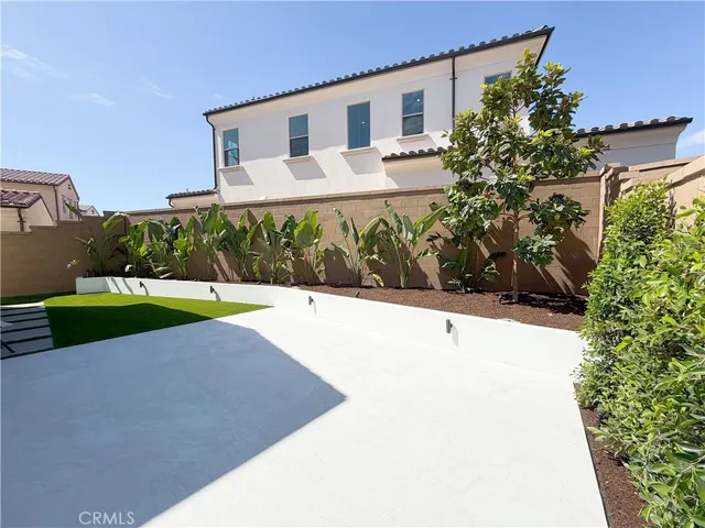 a white building with trees in the background