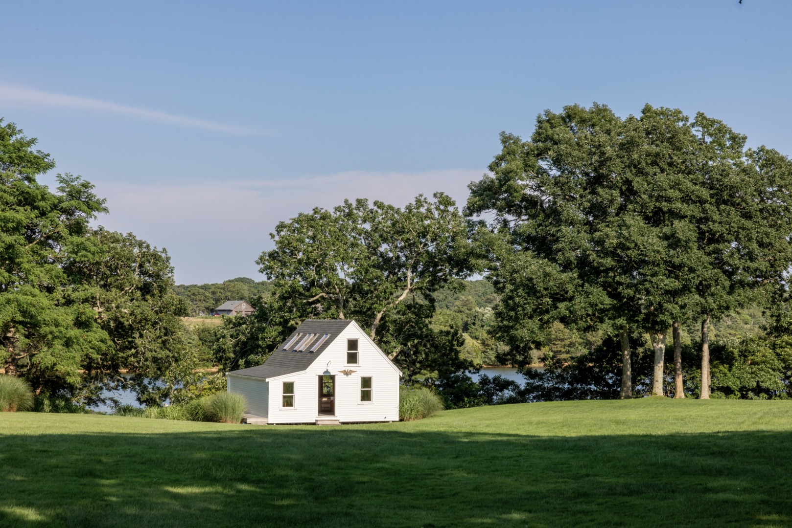 41 Cobbs Hill Road Chilmark, MA 02535 - Photo 20 of 46 a view of a white house with a yard